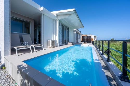 a swimming pool in the backyard of a house at COCO VILLLA 沖縄今帰仁-Okinawa nakijin in Nakijin