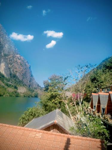a view of a lake with mountains in the background at Views Backpackers Hostel in Nongkhiaw