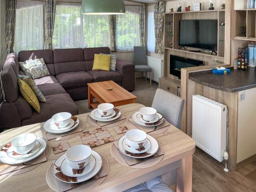 a living room with a table with dishes on it at Maggie's Place in Dunkeld