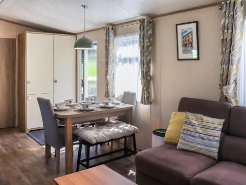 a living room with a table and a couch at Maggie's Place in Dunkeld