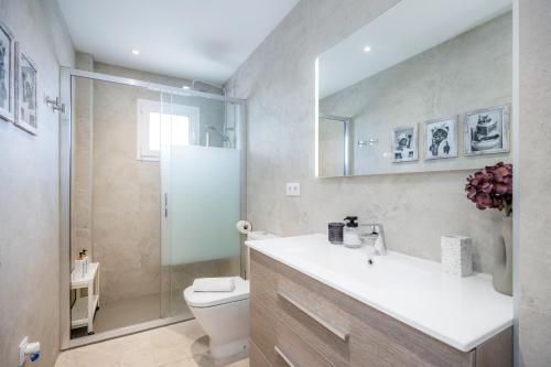 a bathroom with a toilet and a sink and a shower at Apartamento Lliteras 2C Ref 9003 in Cala Millor