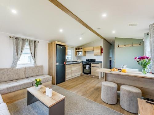 a kitchen and living room with a couch and a table at No29 - Uk52060 in Hartland