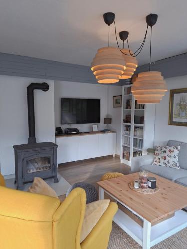a living room with a table and a fireplace at Villa Arboreta in Tuhelj