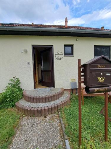 a house with a grill in front of it at Ferienhof Augustenruh in Augustenruh