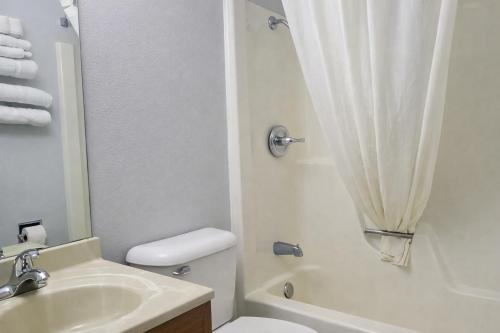 a bathroom with a sink and a toilet and a shower at Algona Inn in Algona