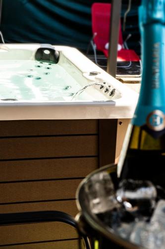 a bottle of wine sitting on top of a table at Nyugágy Apartman in Gárdony