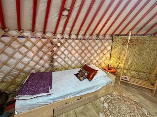 a bedroom with a bed in a yurt at Yourte avec bain nordique in Quimper
