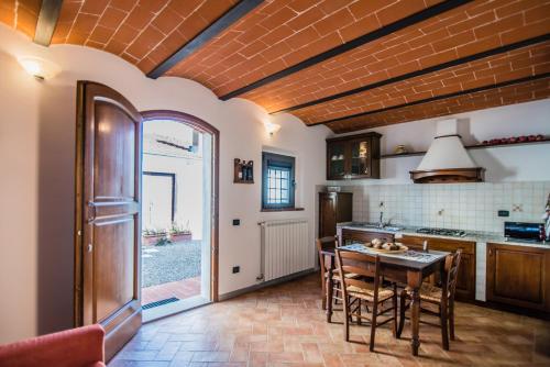 a kitchen with a table and chairs in a room at Agriturismo Spazzavento in Vinci