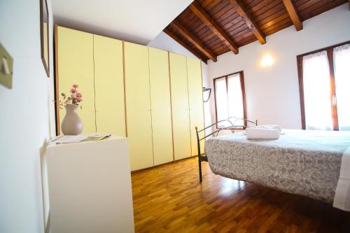a bedroom with a bed and a vase on a table at Guest House Rossana in Reggio Emilia