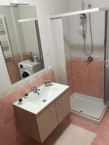 a bathroom with a sink and a shower and a mirror at Incanto Stabiese in Castellammare di Stabia