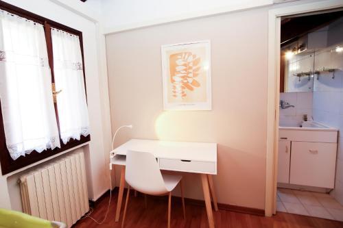 a small room with a white desk and a window at Guest House Rossana in Reggio Emilia