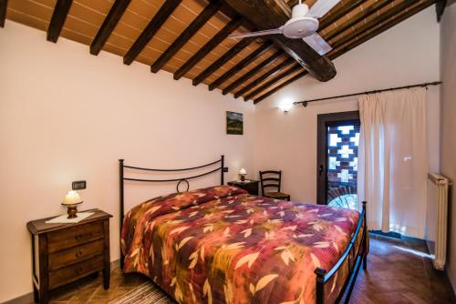 a bedroom with a bed and a ceiling fan at Agriturismo Spazzavento in Vinci