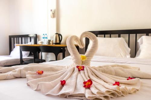 a couple of swans are sitting on a bed at Patong Canal Villa 308 in Patong Beach
