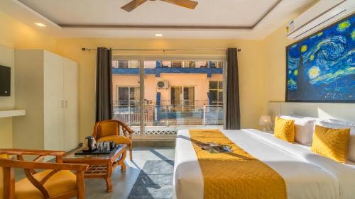 a bedroom with a bed and a table and a chair at The Social Stays Rishikesh in Rishīkesh