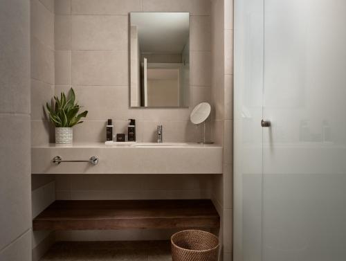 a bathroom with a sink and a mirror at Asterion Suites & Spa - Designed for Adults in Gerani