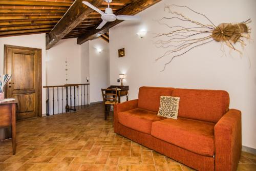 a living room with a couch and a ceiling fan at Agriturismo Spazzavento in Vinci