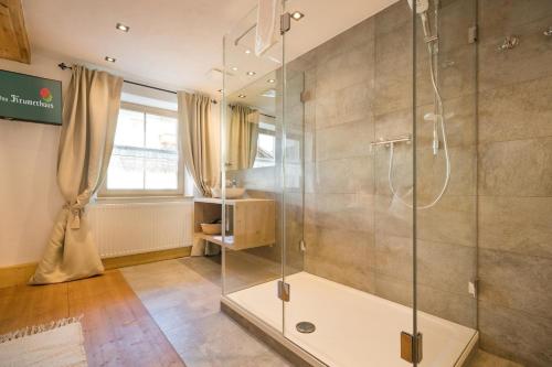 a bathroom with a shower with a glass door at Das Krumerhaus in Aschau