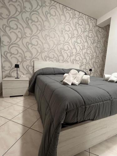 a bedroom with a large bed with a wall at Incanto Stabiese in Castellammare di Stabia