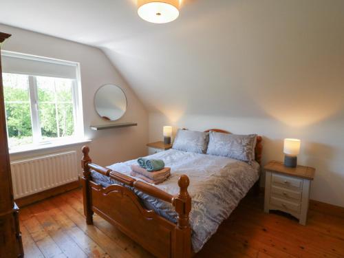 a bedroom with a bed with two lamps and a window at The Skating Rock in Banane Bridge
