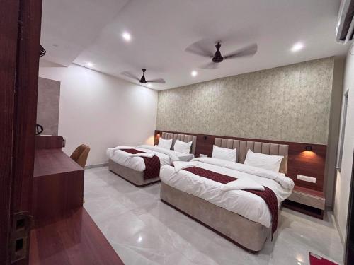 a bedroom with two beds in a room at Raghuwar Palace in Ayodhya