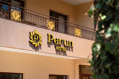 a hotel sign on the side of a building at Hotel Perun in Budva