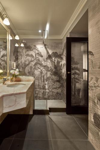 a bathroom with a large mural on the wall at Hotel Accademia in Verona