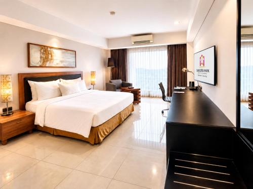 a hotel room with a bed and a desk at Sakura Park Hotel & Residence in Bekasi
