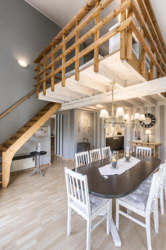 a dining room and living room with a table and chairs at Chalet de Cligneval in Malmedy