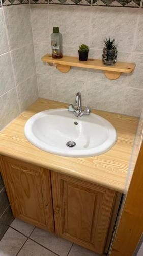 a bathroom counter with a sink and a sink at Au Coin des Souvenirs in Malbuisson