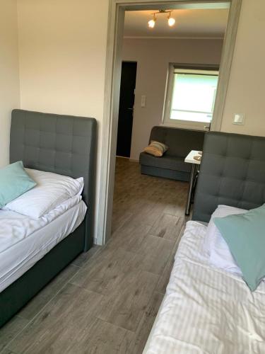 a living room with two beds and a couch at Lazurowy Zakątek in Dąbki