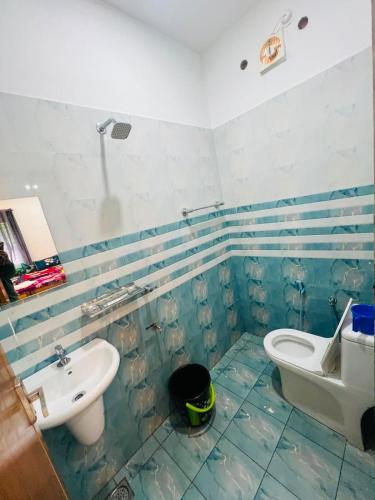 a bathroom with a toilet and a sink at Rooms Varkala Homestay in Varkala