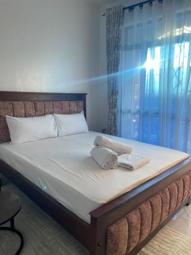 a bed with two towels sitting on top of it at royalnest bnb in Mombasa