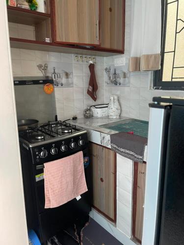a small kitchen with a stove and a sink at royalnest bnb in Mombasa