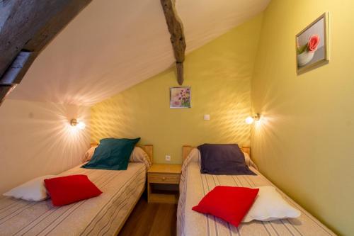 two beds in a room with yellow walls at Moulin neuf de combecave pour 6 in Saint-Amand-de-Vergt