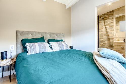 a bedroom with a large bed with blue sheets at La Luna in Jijona