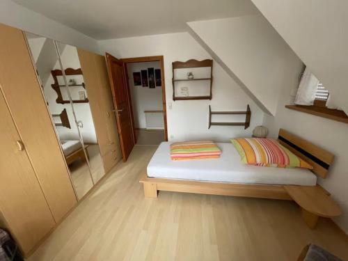 a small bedroom with a bed in a attic at Ferienwohnung Ahrtalfreude in Sinzig