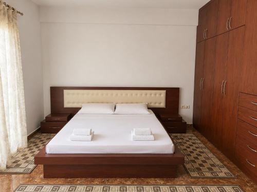 a bedroom with a bed with two pillows on it at Berat Skyline Apartment in Berat