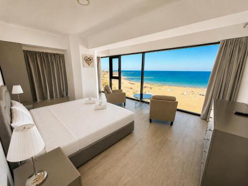 a bedroom with a bed and a view of the beach at Maritimo ApartHotel in Constanţa