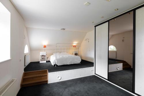 a bedroom with a bed and a large mirror at Appartement Overcinge in Havelte