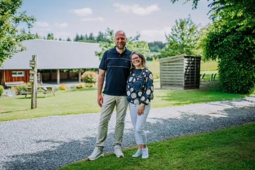 a man and a woman standing on the grass at Gîte de la Cour in Campandré-Valcongrain