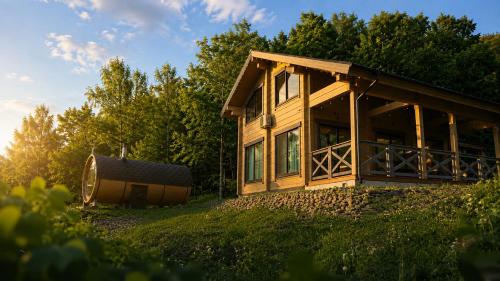 a wooden house on a hill next to trees at MATRYOSHKA HOUSE 2nd GUEST HOUSE in Yoichi