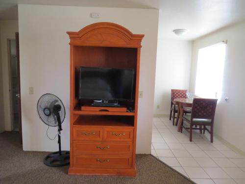 a wooden entertainment center with a television and a table at Laguna Lodge in Marina