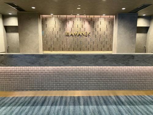 a wall with a sign that reads the amway at HOTEL AMANEK Kumamoto in Kumamoto