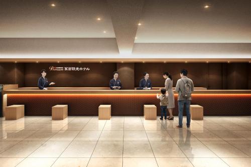 a group of people standing in a waiting room at Ooedo Onsen Monogatari Premium Minoh Kanko Hotel in Minoo
