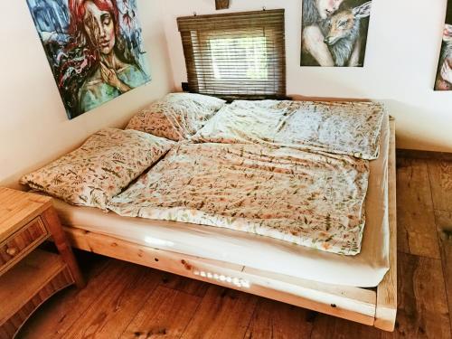 a bed in a room with posters on the wall at Tinyhouse ATELIÉR u Těrlické přehrady in Horní Těrlicko