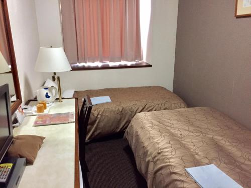 Cama o camas de una habitación en Hotel Sunroute Fukushima