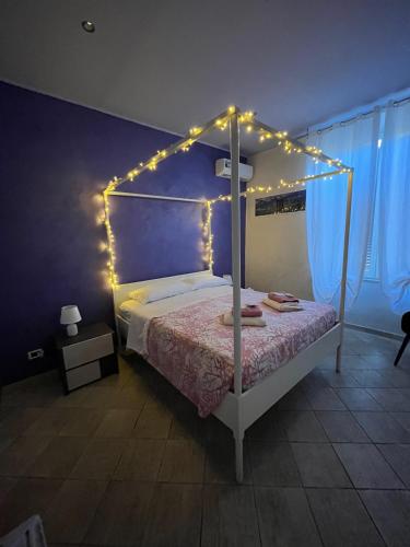 a bedroom with a bed with lights on it at Il Corallo in Terracina