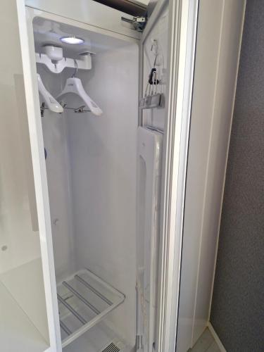a white refrigerator with its door open at Sj라벨라 강서 in Samgong