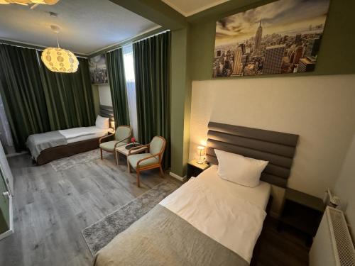 a hotel room with a bed and a chair at Limo Stay in Neuhausen auf den Fildern