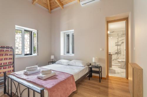 a bedroom with a bed and a walk in shower at Ionian Home in Exanthia